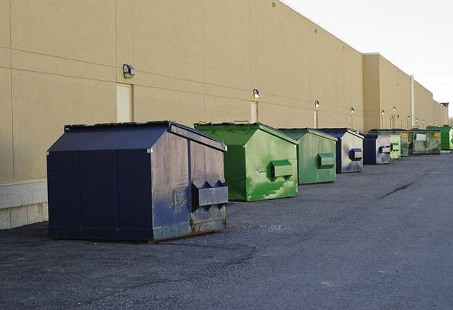 construction crew disposing of building materials in large bins in Columbia Heights, MN